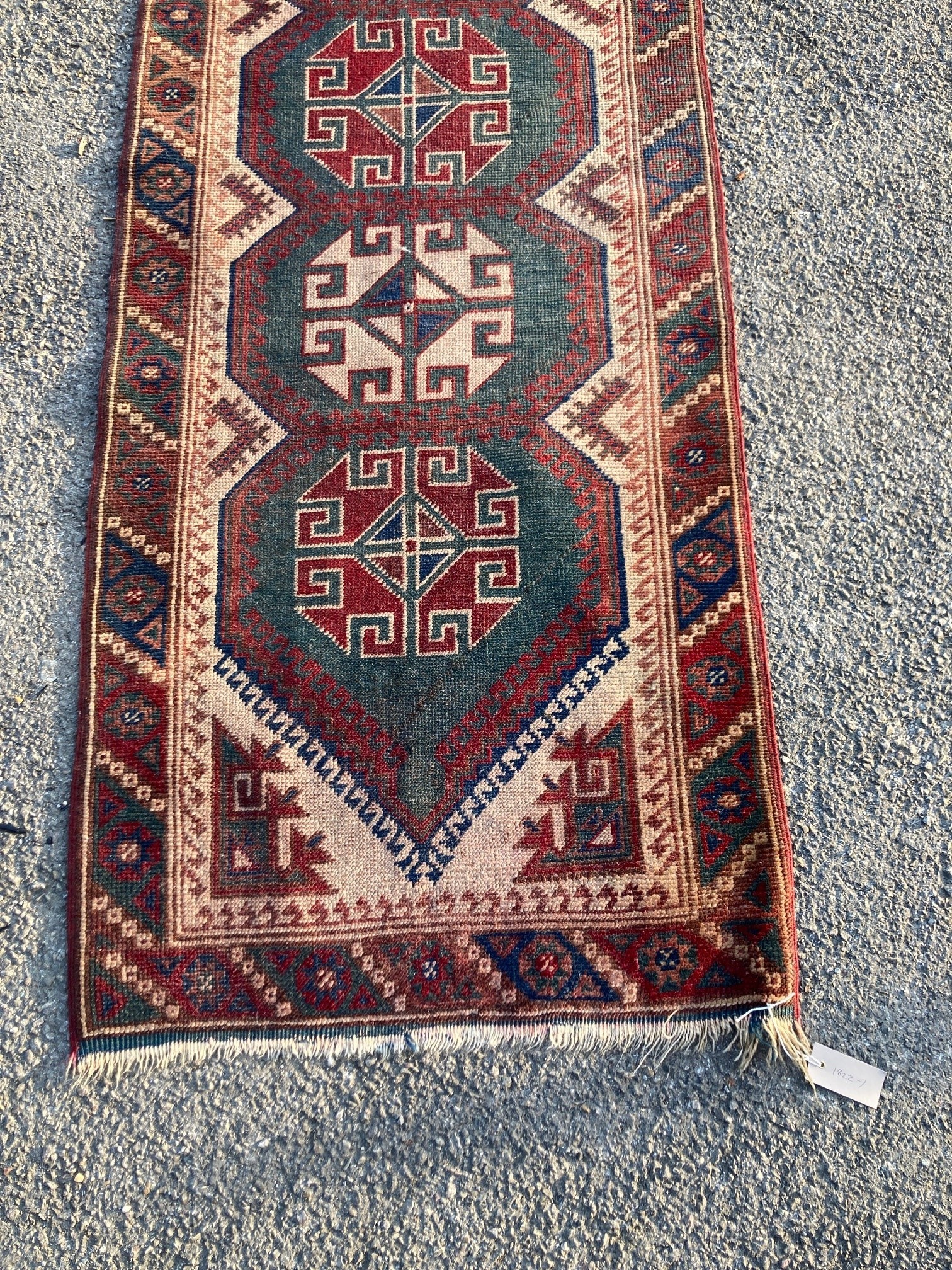 A Caucasian design green ground runner, 340 x 76cm